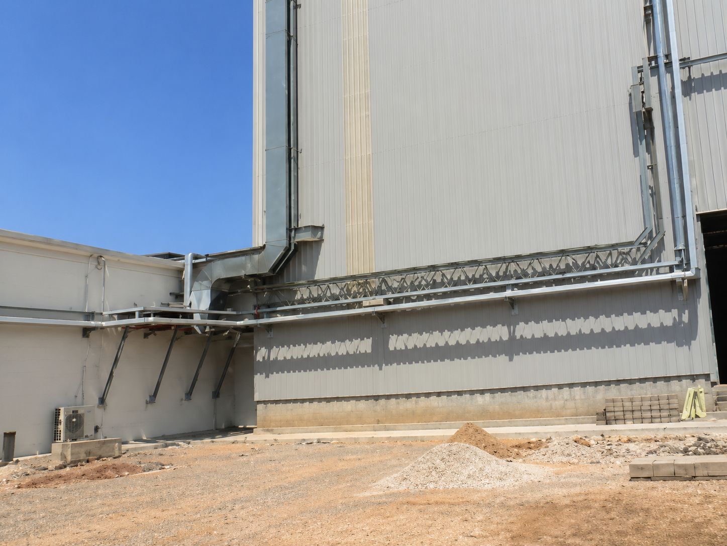 Galvanised cable containment routed along the external wall of a silo structure